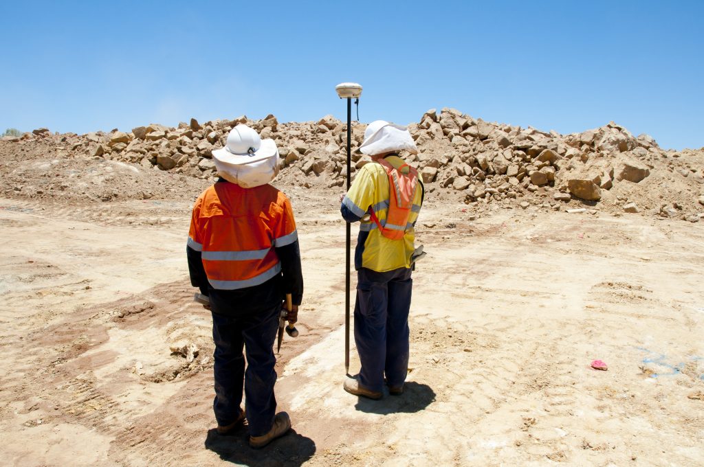 Two land surveyors working on a project n Odessa, Texas